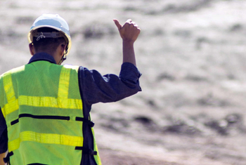 worker in safety vest giving thumbs up