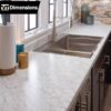 Carrara Bianco Laminate used as countertop in a kitchen with brown cabinets.