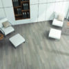 Top view of luxury office waiting room with white and wooden walls, two white leather armchairs with round coffee tables near them and bookcase with folders.