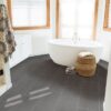 Graphite Focus Porcelain Tile 12" X 24" in a bathroom with a tub